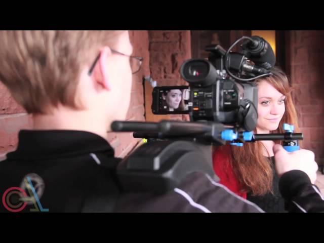 A young filmmaker filming an actress with a dslr camera